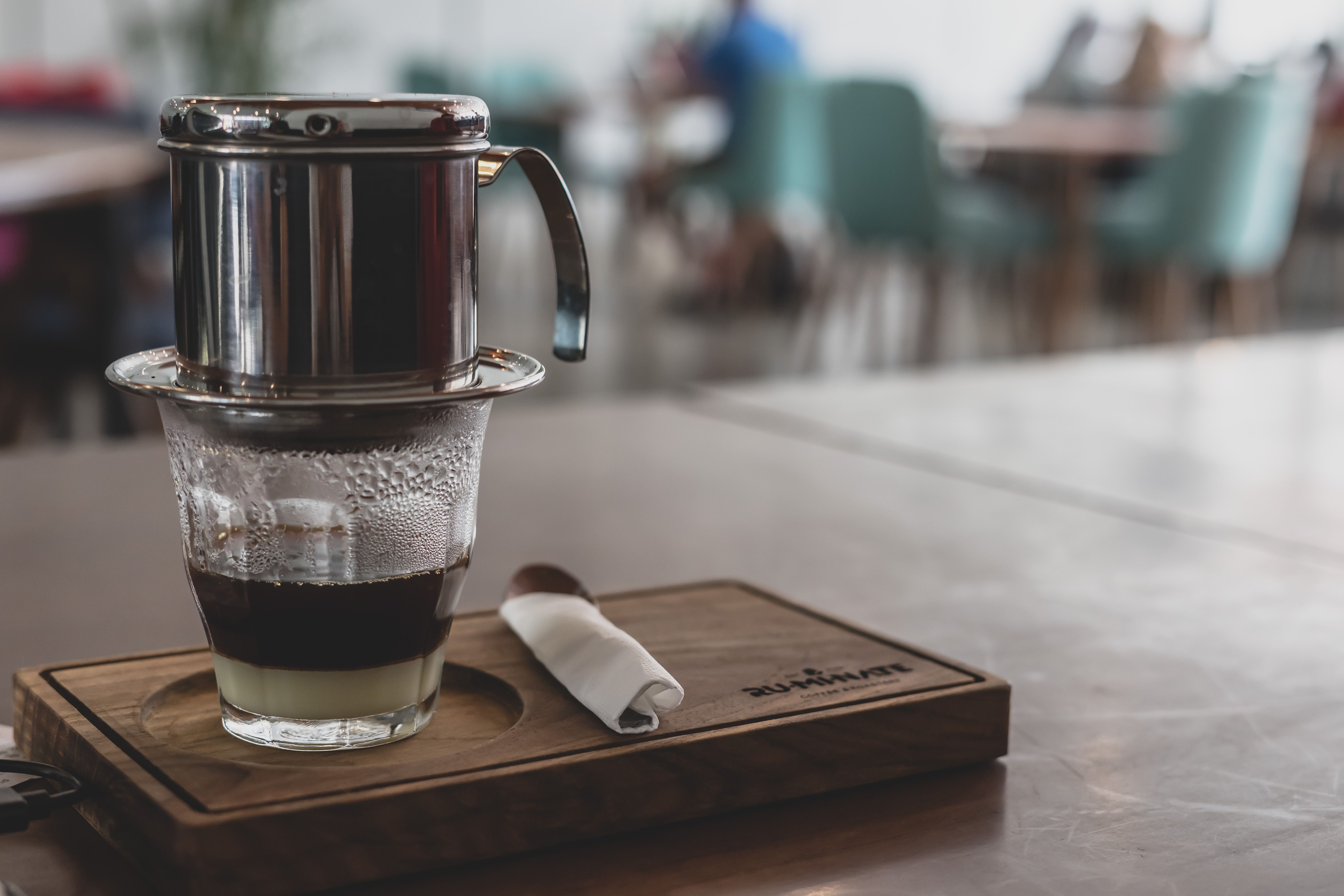 Vietnamese coffee dripping through phin filter